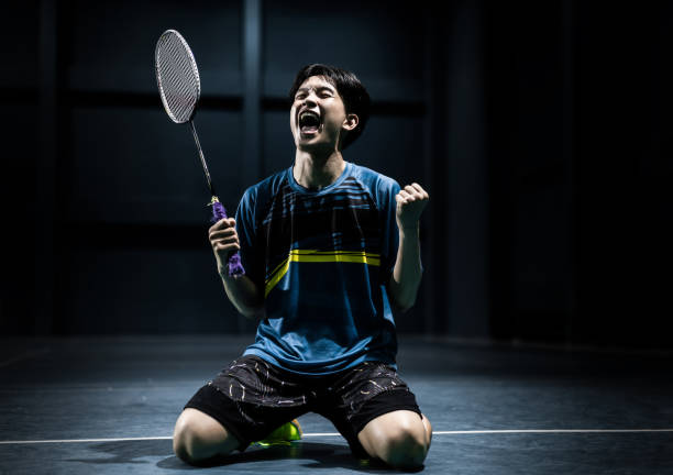 Asian badminton player is glad that he wins
competition